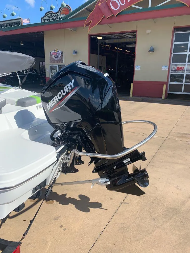 Slide: The Image of 2023 Tahoe T16 boat with Mercury outboard motor in a dealership lot. - 3
