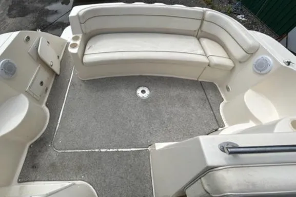 Slide: The Image of 2003 Rinker 290 Fiesta Vee boat interior with curved seating and carpeted floor. - 12