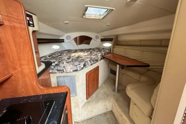 Slide: The Image of Interior of 2003 Rinker 290 Fiesta Vee boat with cozy seating and sleeping area. - 15