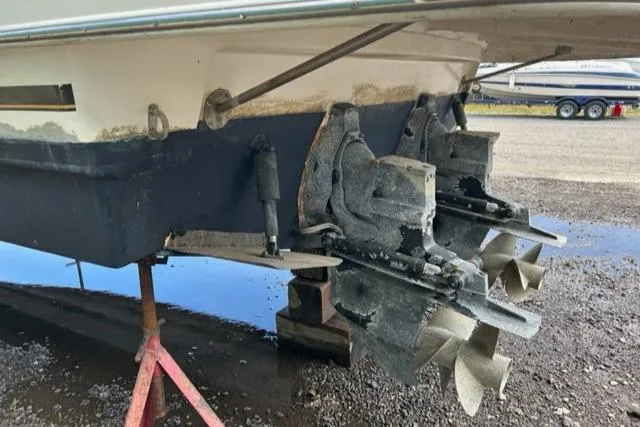 Slide: The Image of 2003 Rinker 290 FIESTA VEE boat stern with dual propellers on dry dock. - 22