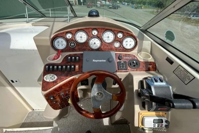 Slide: The Image of 2003 Rinker 290 Fiesta Vee boat dashboard with gauges and controls. - 3