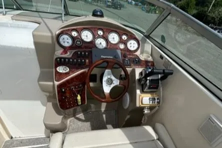 Slide: The Image of 2003 Rinker 290 Fiesta Vee boat dashboard with gauges and steering wheel. - 4