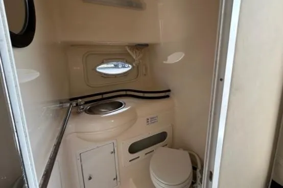Slide: The Image of 2003 Rinker 290 Fiesta Vee boat bathroom with sink and toilet. - 9