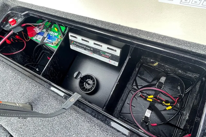 Slide: The Image of 2024 Ranger Z519 boat battery compartment with wiring and charger. - 15