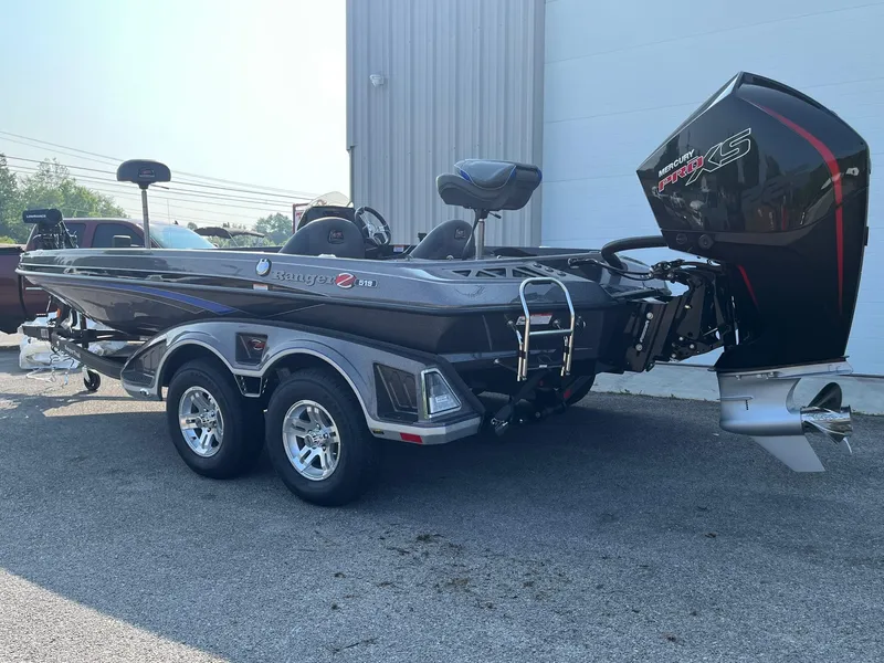Slide: The Image of 2024 Ranger Z519 fishing boat with dual-axle trailer and powerful outboard motor. - 16