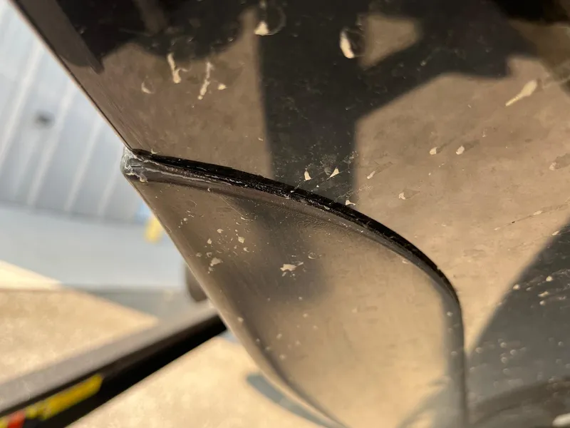 Slide: The Image of Close-up of a 2024 Ranger Z519 boat hull with minor scratches. - 2