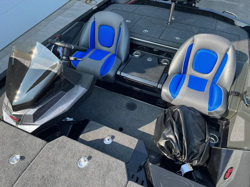 Slide: The Image of 2024 Ranger Z519 boat interior with blue and gray seats, steering console, and storage compartments. - 7