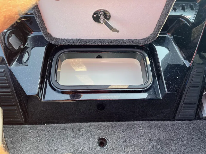 Slide: The Image of 2024 Ranger Z519 boat storage compartment with open lid and key lock. - 8