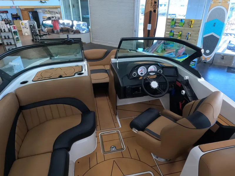 Slide: The Image of 2023 MB B52 Alpha boat interior with tan and black seating, dashboard, and steering wheel. - 15