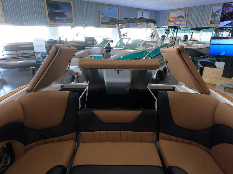 Slide: The Image of 2023 MB b52 alpha boat interior with tan and black seating in showroom. - 20