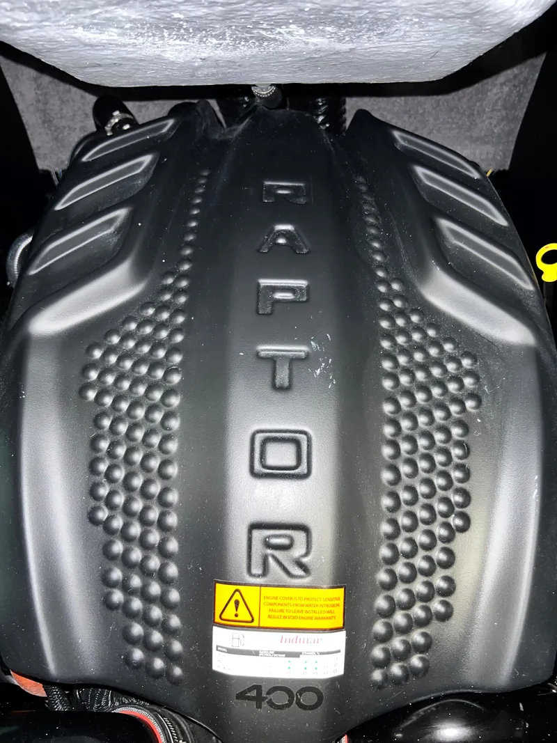 Slide: The Image of 2023 MB b52 alpha Raptor 400 engine cover with textured design. - 21