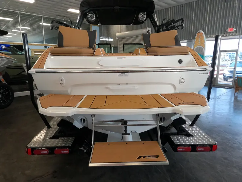 Slide: The Image of 2023 MB B52 Alpha boat rear view in showroom with teak deck. - 8