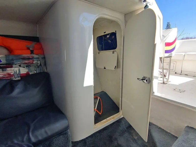 Slide: The Image of Interior of 1999 Baha Cruisers 290 Mach 1 boat with open cabin door. - 11