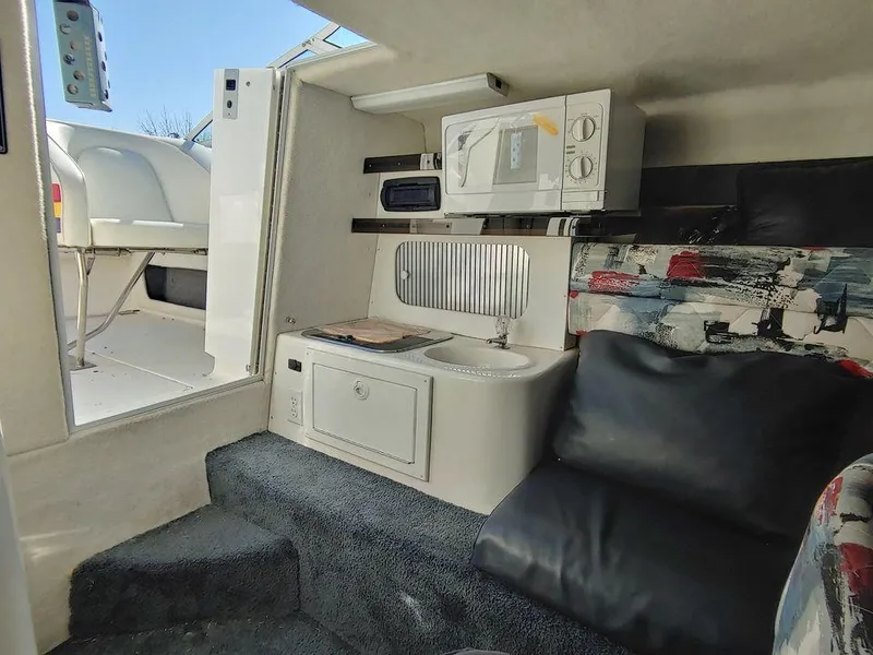 Slide: The Image of Interior of 1999 Baha Cruisers 290 Mach 1 with kitchenette and seating area. - 12