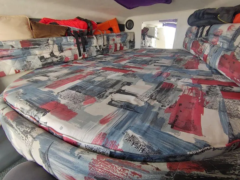 Slide: The Image of Interior cabin of a 1999 Baha Cruisers 290 Mach 1 with colorful bedding. - 13