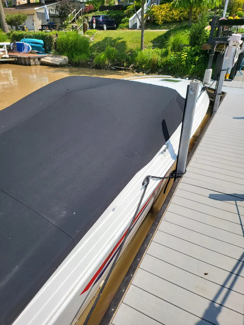 Slide: The Image of 1999 Baha Cruisers 290 Mach 1 boat docked with black cover. - 19