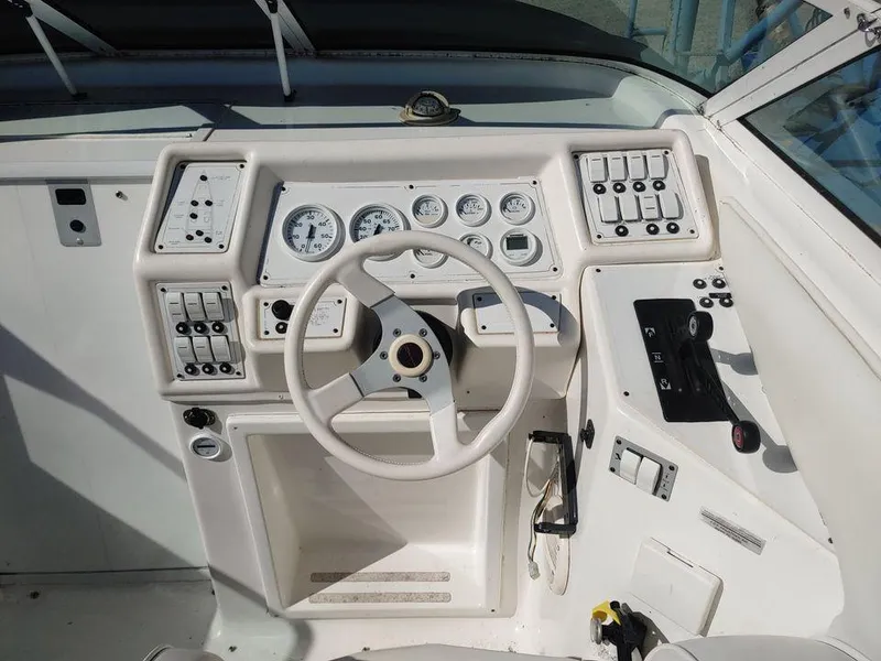 Slide: The Image of 1999 Baha Cruisers 290 Mach 1 boat helm with steering wheel and control panel. - 2