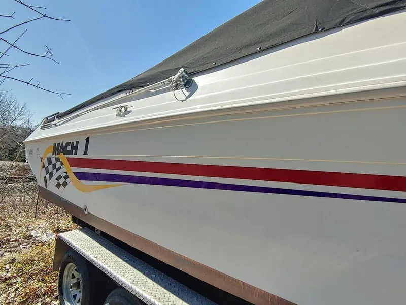 Slide: The Image of 1999 Baha Cruisers 290 Mach 1 boat side view with colorful stripes. - 20