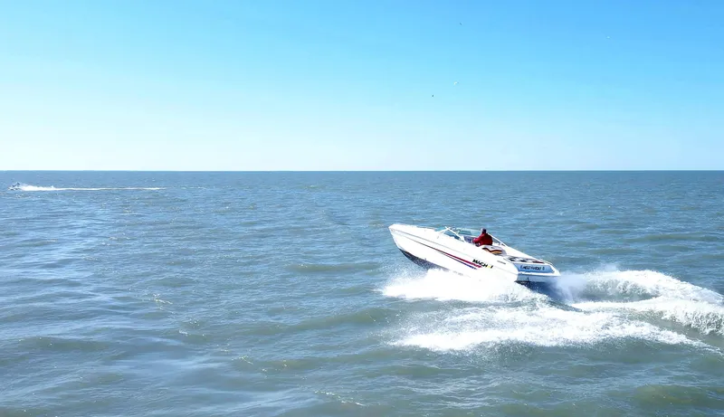 Slide: The Image of 1999 Baha Cruisers 290 Mach 1 speedboat cruising on open water. - 4