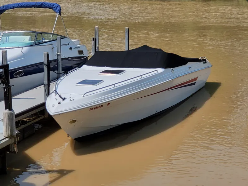 Slide: The Image of 1999 Baha Cruisers 290 Mach 1 boat docked with black cover. - 5