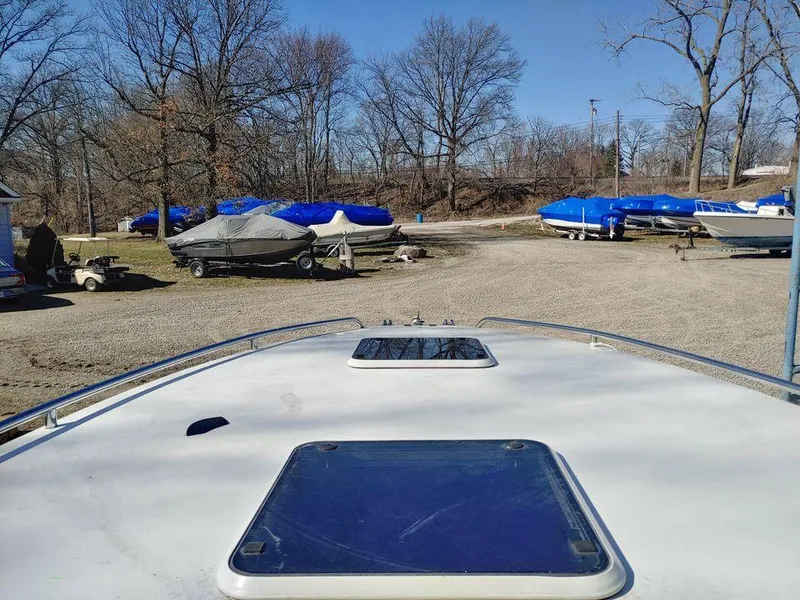 Slide: The Image of 1999 Baha Cruisers 290 Mach 1 boat in storage yard with other covered boats. - 6