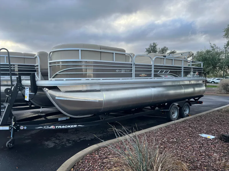 The Image of 2023 Sun Tracker SportFish 22 XP3 pontoon boat on a trailer. - 0