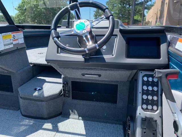 Slide: The Image of 2023 Ranger VX1788 WT boat dashboard with steering wheel and control panel. - 1