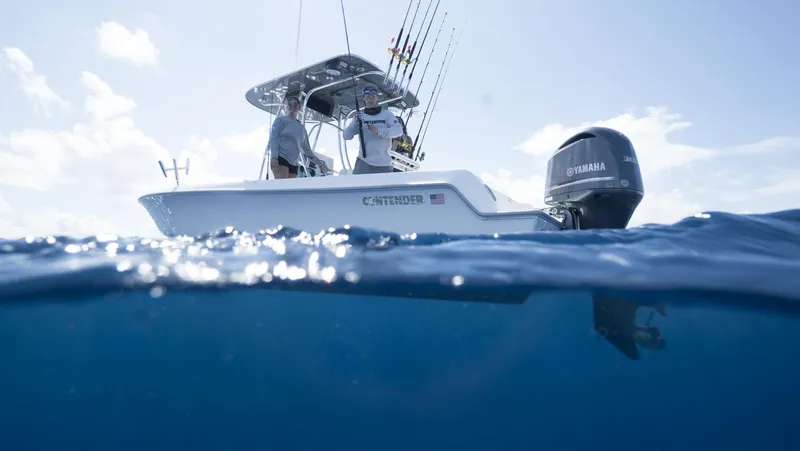 Slide: The Image of 2024 Contender 24S fishing boat on the water with Yamaha outboard motor. - 2