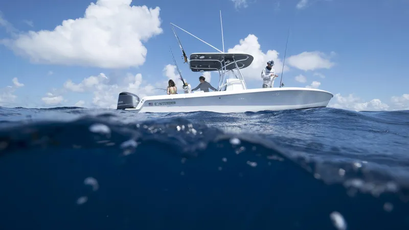 Slide: The Image of 2024 Contender 24S boat on open water with people fishing. - 3