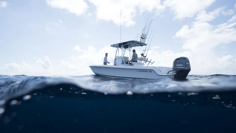 Slide: The Image of 2024 Contender 24S boat on open water with fishing gear. - 6