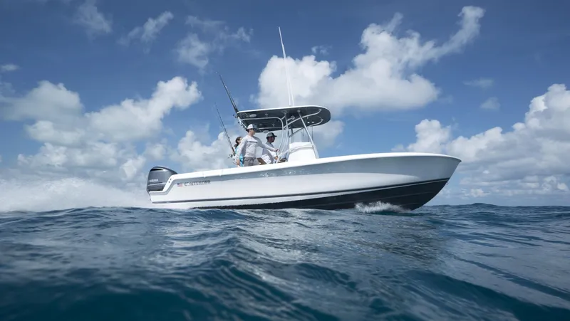 Slide: The Image of 2024 Contender 24S boat cruising on open water under a clear sky. - 8