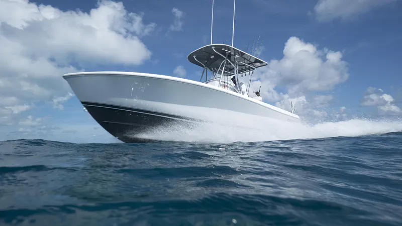 Slide: The Image of 2024 Contender 24S boat cruising on open water under blue sky. - 9