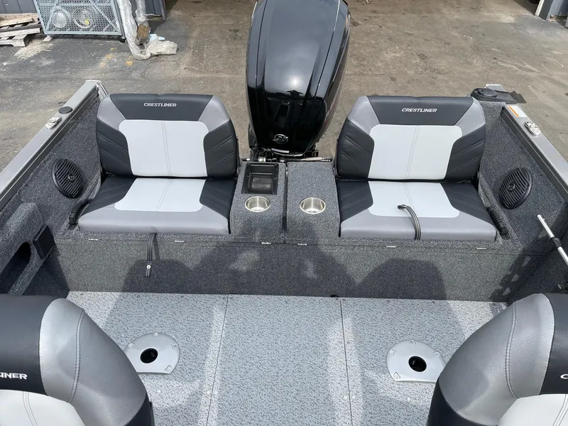 Slide: The Image of 2023 Crestliner 1650 Fish Hawk boat interior with dual seats and motor. - 2