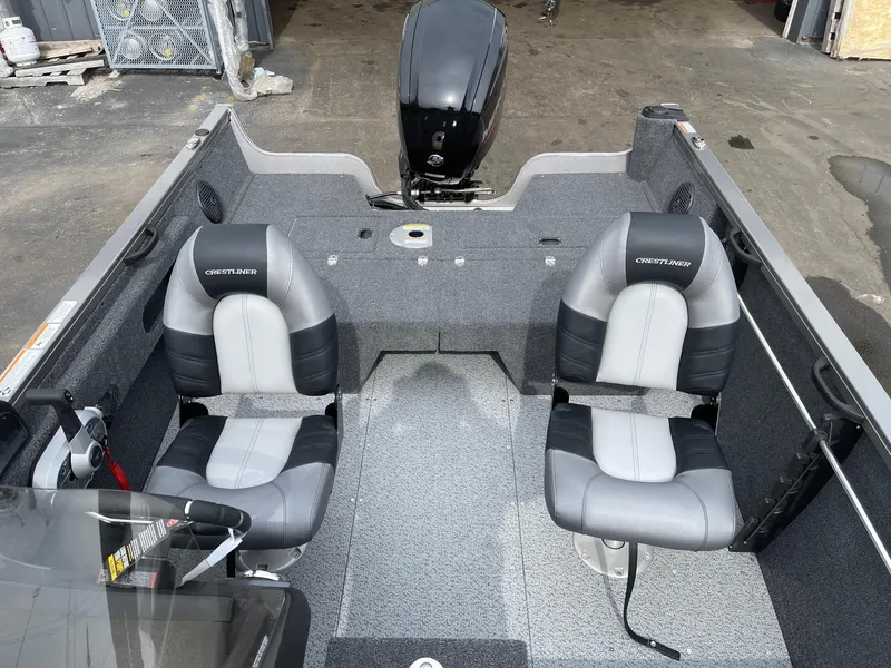 Slide: The Image of 2023 Crestliner 1650 Fish Hawk boat interior with two seats and motor. - 3