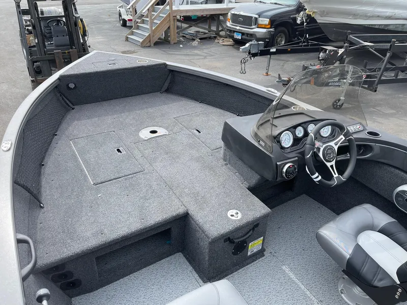 Slide: The Image of 2023 Crestliner 1650 Fish Hawk boat interior with steering console and seating. - 4