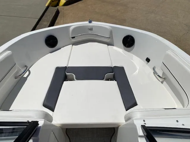 Slide: The Image of 2024 Bayliner VR5 boat interior with cushioned seating and speakers. - 10