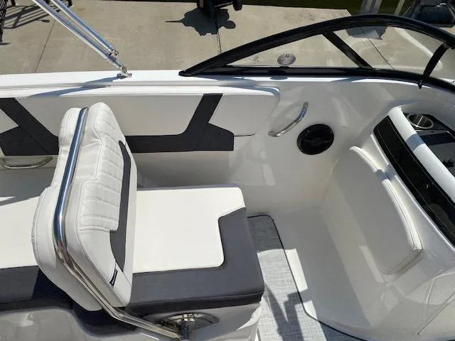 Slide: The Image of 2024 Bayliner VR5 boat interior with white and gray seating, sleek design. - 12