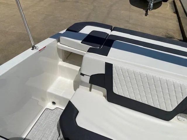 Slide: The Image of 2024 Bayliner VR5 boat interior with white and black seating. - 15