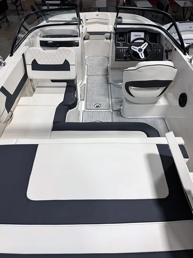 Slide: The Image of 2024 Bayliner VR5 boat interior with modern seating and steering console. - 5