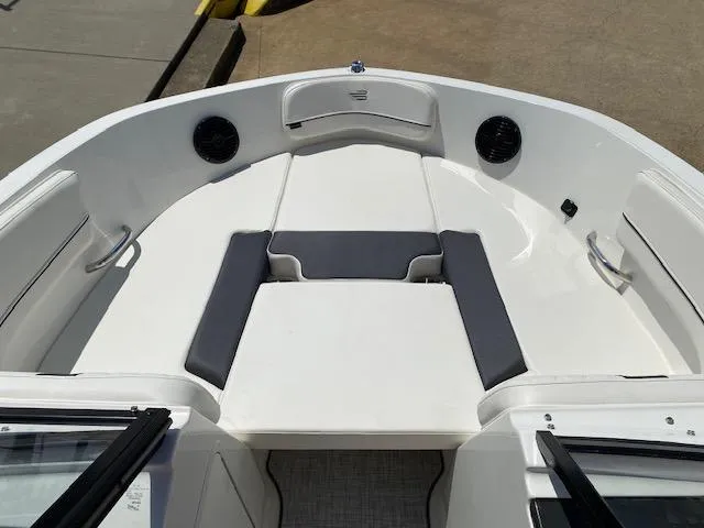 Slide: The Image of 2024 Bayliner VR5 boat interior with white and gray seating. - 6