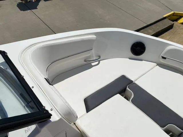 Slide: The Image of 2024 Bayliner VR5 boat interior with white seating and black speaker. - 7