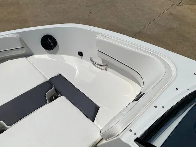 Slide: The Image of 2024 Bayliner VR5 boat interior with white and gray seating. - 9