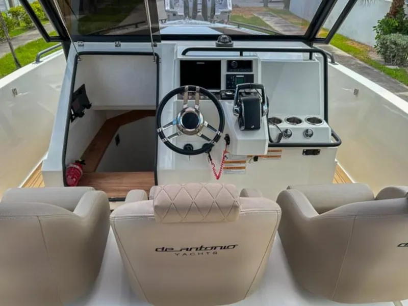 Slide: The Image of 2024 De Antonio Yachts D28 Xplorer cockpit with steering wheel and control panel. - 13