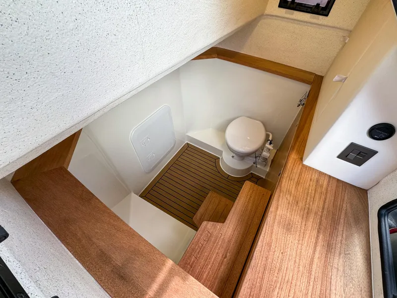 Slide: The Image of 2024 De Antonio Yachts D28 Xplorer interior with wooden flooring and compact bathroom. - 14