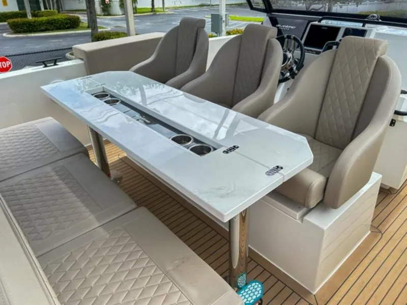 Slide: The Image of 2024 De Antonio Yachts D28 Xplorer interior with luxurious seating and sleek table design. - 16