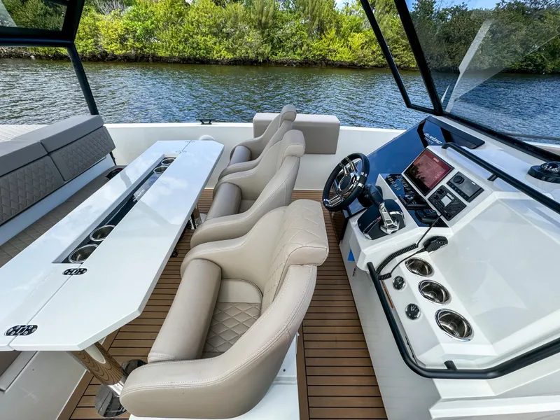 Slide: The Image of 2024 De Antonio Yachts D28 Xplorer interior with luxurious seating and modern dashboard. - 19