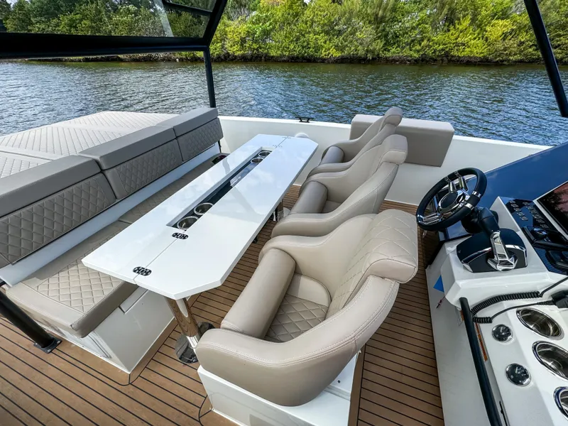 Slide: The Image of 2024 De Antonio Yachts D28 Xplorer interior with luxurious seating and sleek design on the water. - 20