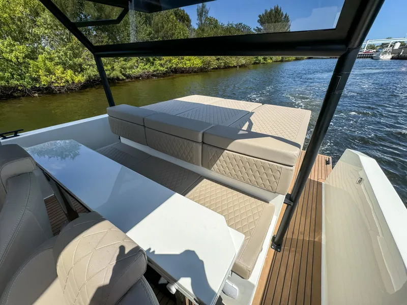 Slide: The Image of 2024 De Antonio Yachts D28 Xplorer interior with beige seating and sleek design on a sunny day. - 21