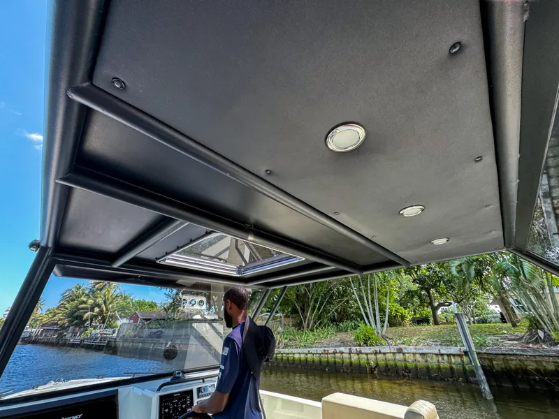 Slide: The Image of 2024 De Antonio Yachts D28 Xplorer cruising on a scenic waterway. - 25