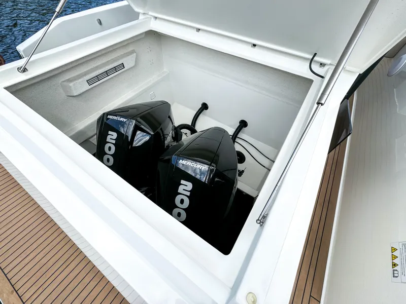 Slide: The Image of 2024 De Antonio Yachts D28 Xplorer with dual Mercury 200 engines in open compartment. - 26